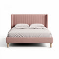 Upholstered king size bed with padded headboard in blush pink fabric