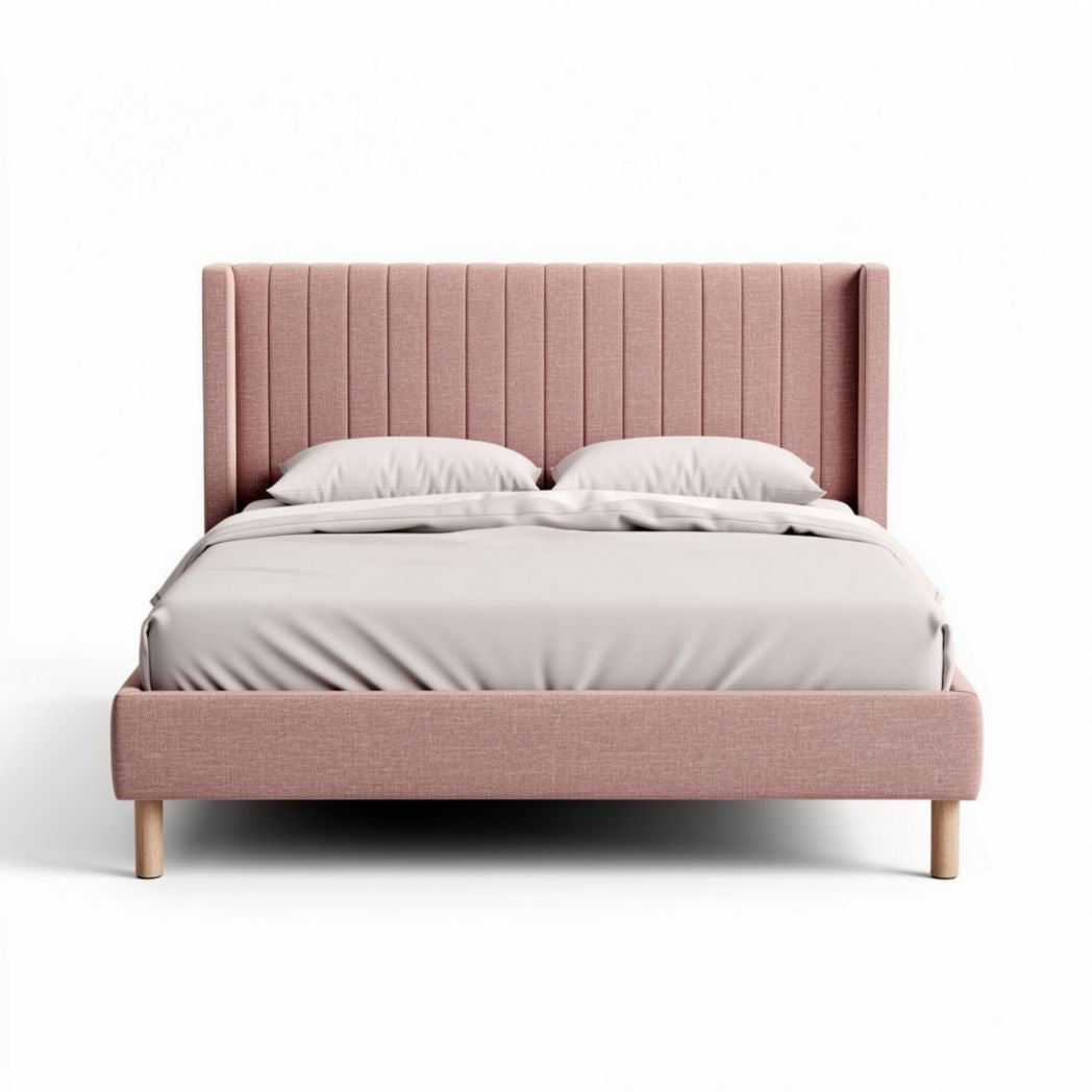 Upholstered king size bed with padded headboard in blush pink fabric